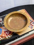 A small vintage Danish bronze vide poche catch all by Argentor circa 1930. This art deco circular metal dish features a whimsical engraved motif of a mermaid riding a dolphin on the centre, authentic patina and tarnished areas which creates the mottled copper and gold tones so beloved in bronze items. Perfect for use as a stylish trinket dish or jewellery holder, particularly within mid century modern, modernist, antique baroque, Hollywood Regency or rustic farmhouse home décor schemes.