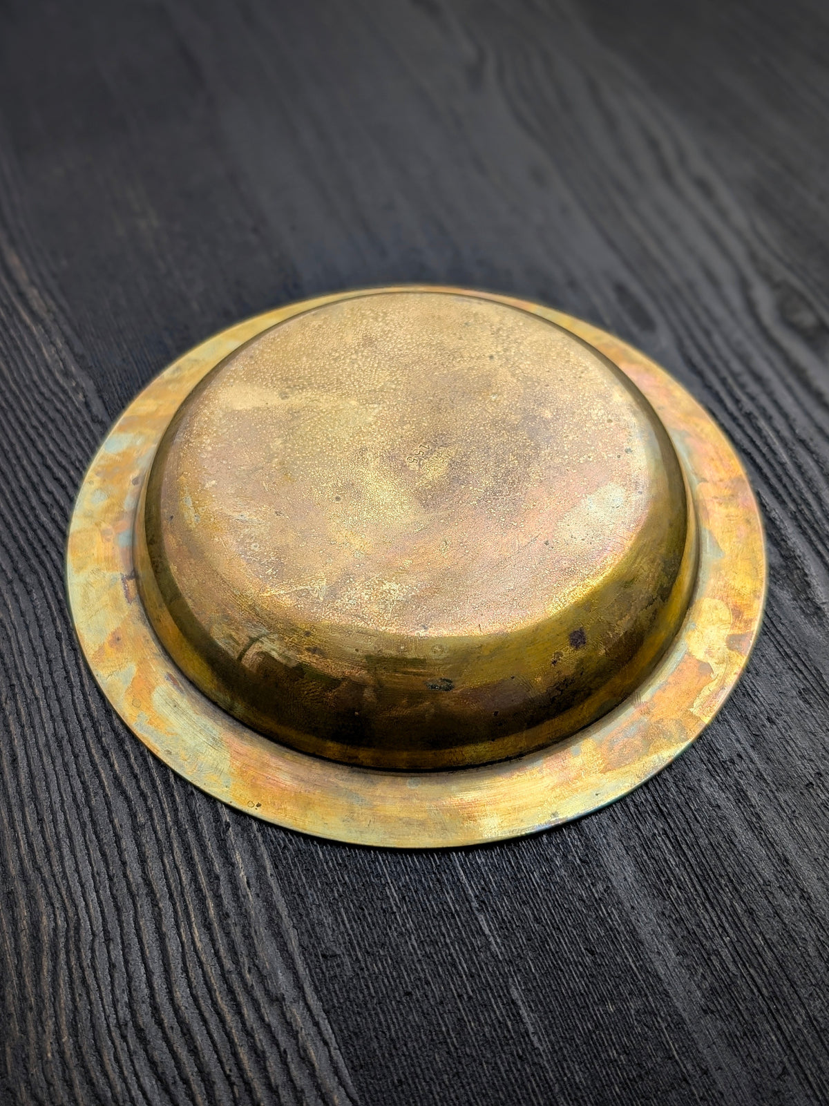 An upturned vintage Danish bronze vide poche catch all by Argentor circa 1930. This art deco circular metal dish features a whimsical engraved motif of a mermaid riding a dolphin on the centre, authentic patina and tarnished areas which creates the mottled copper and gold tones so beloved in bronze items. Perfect for use as a stylish trinket dish or jewellery holder, particularly within mid century modern, modernist, antique baroque, Hollywood Regency or rustic farmhouse home décor schemes.